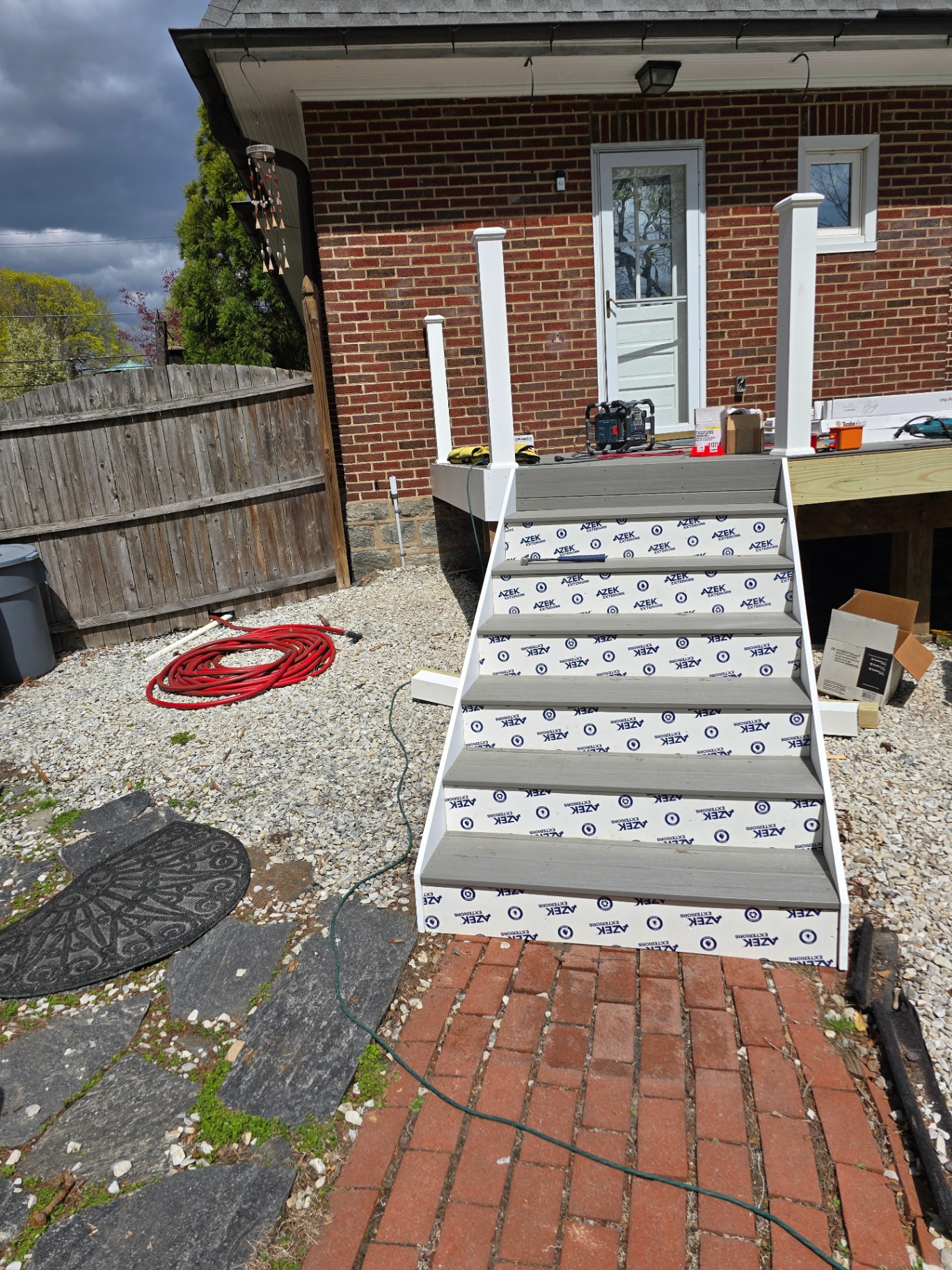 Composite deck stairs with white railings at rear entry