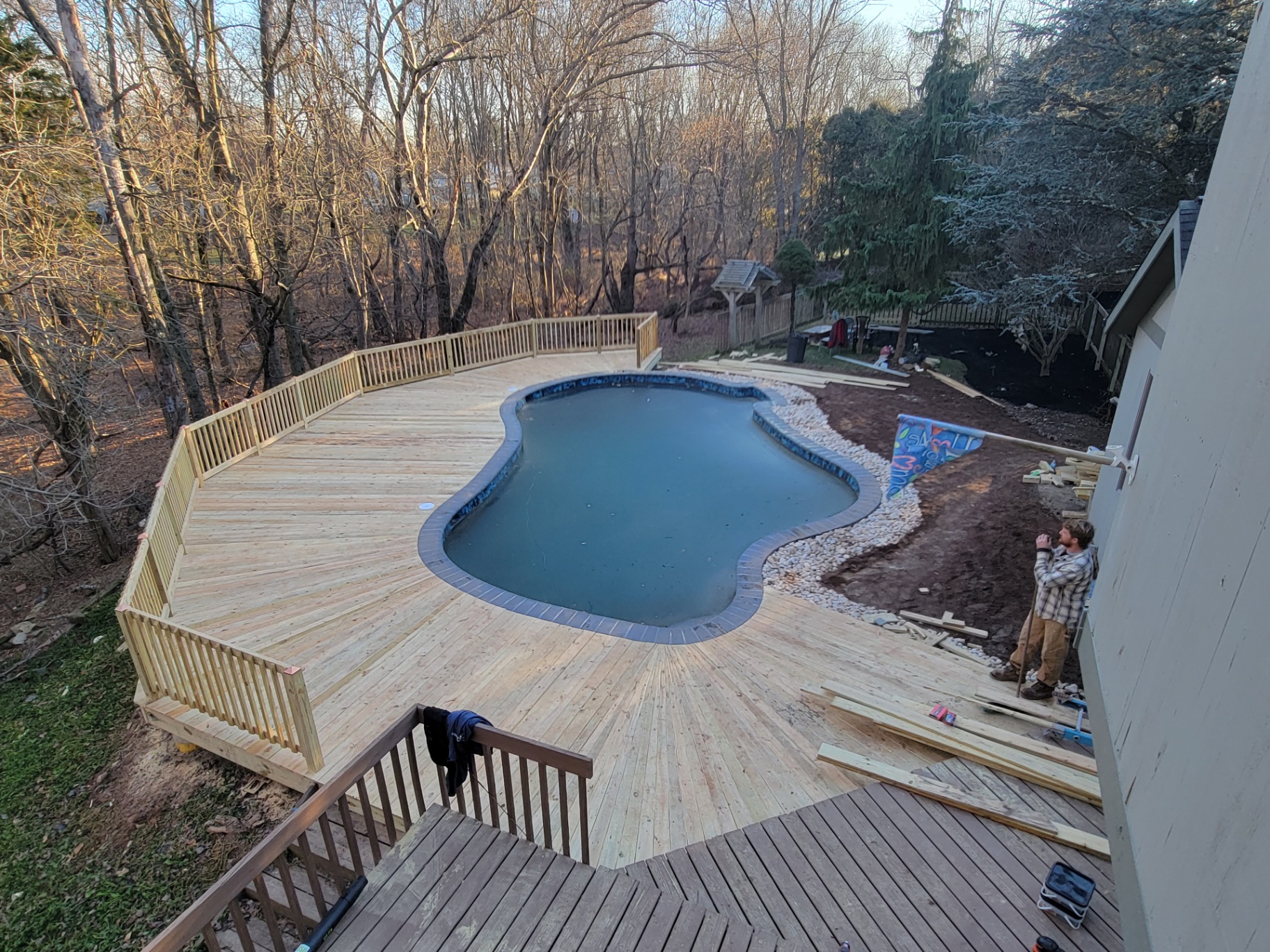 Wood pool deck with railings at sunset