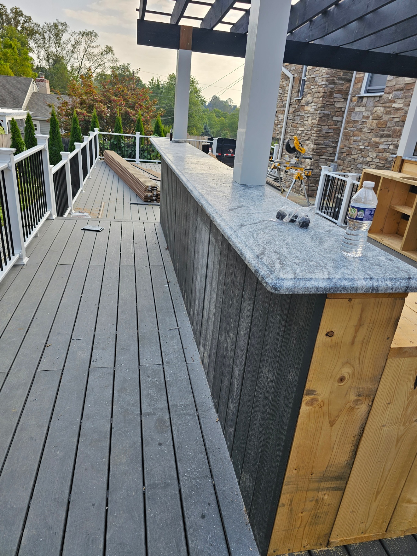 Composite deck with built-in bar, granite top, and pergola