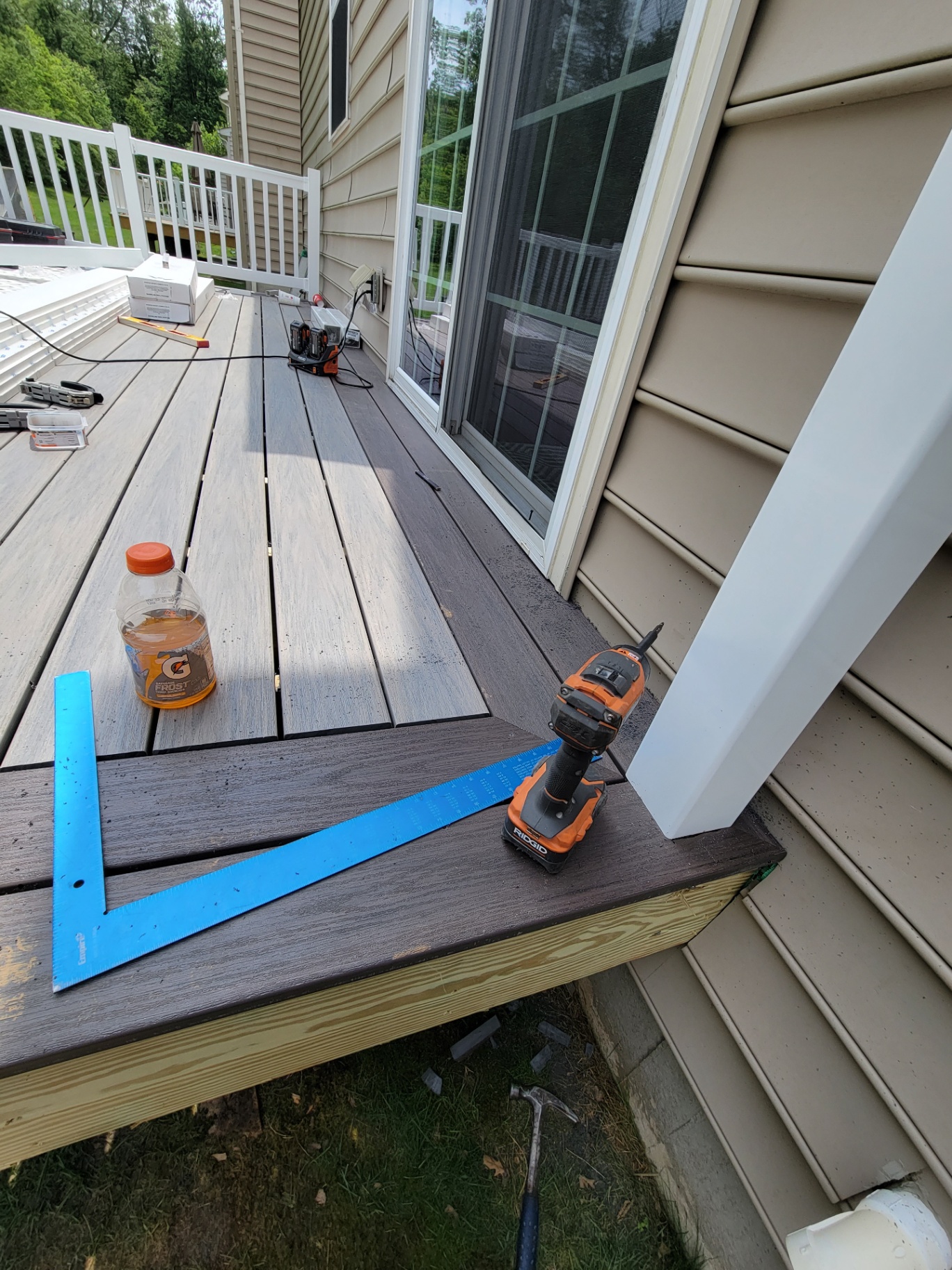 Composite decking installation in progress with framing square