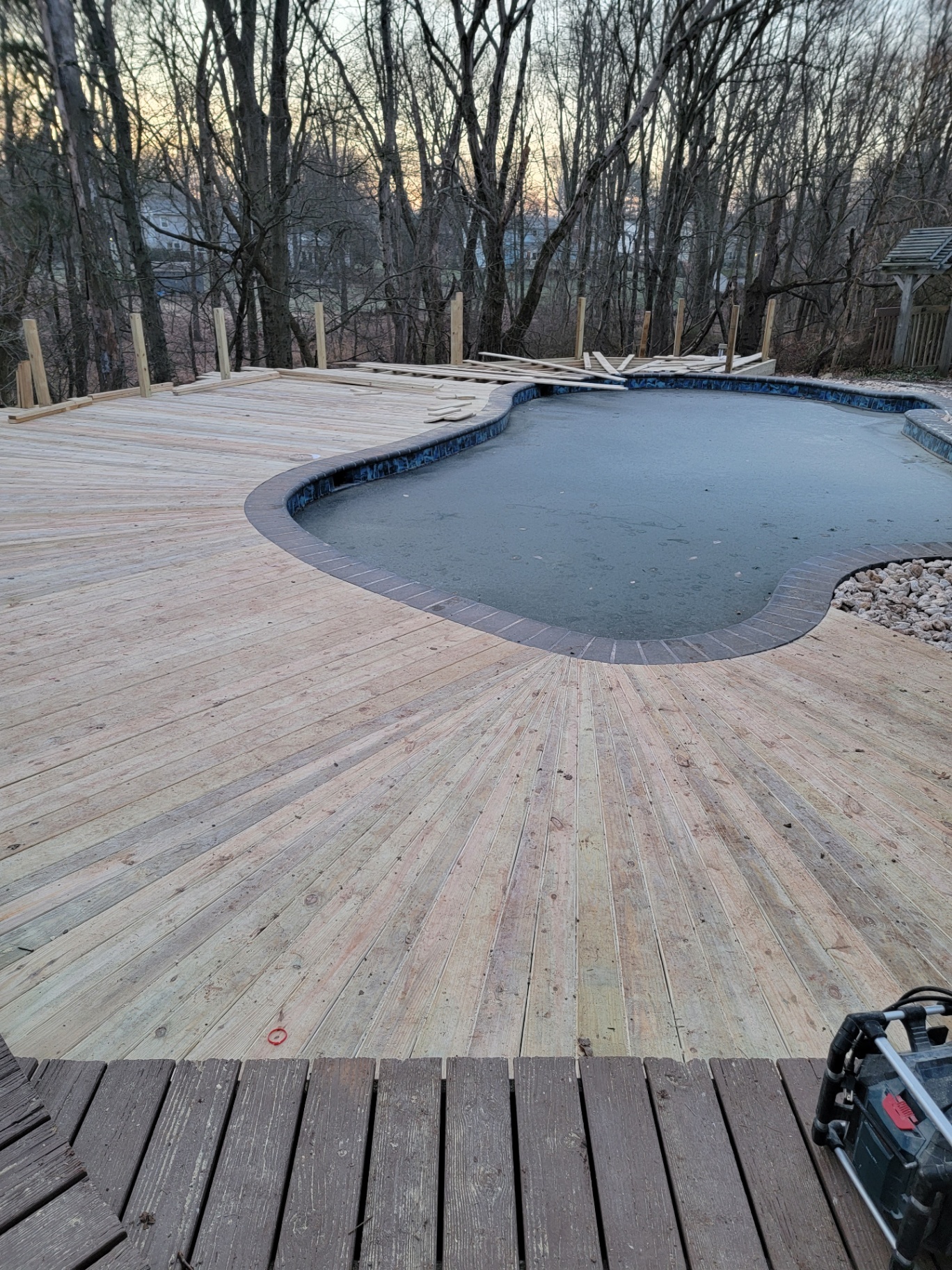 Freshly laid pool decking with radial board pattern