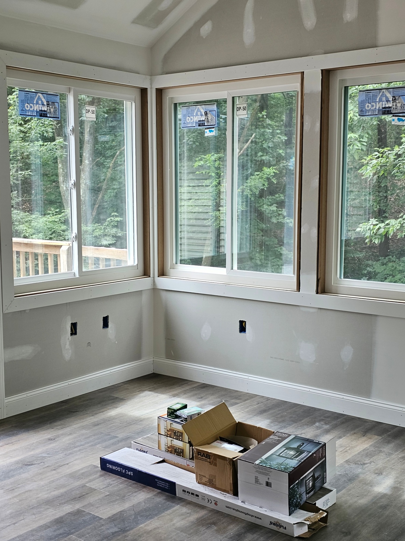 Sunroom corner with new windows and luxury vinyl plank flooring